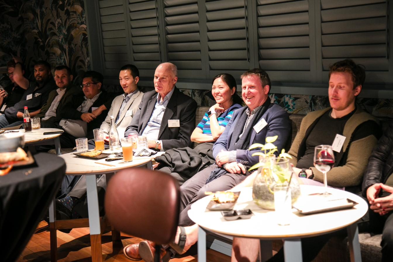 Senior leaders in discussion around a private dining table